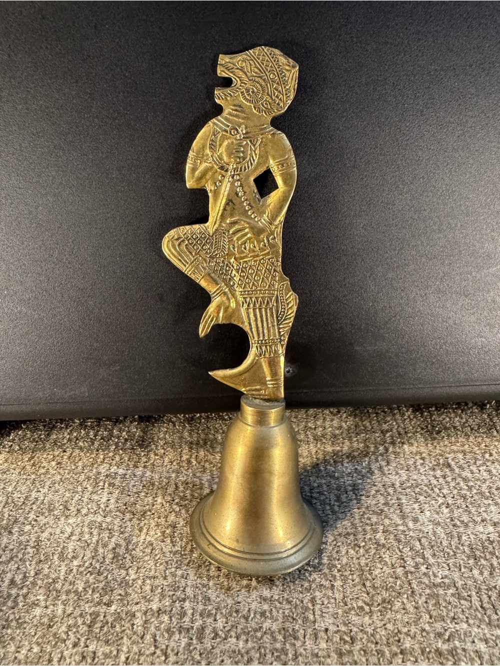 Vintage brass bell featuring a figural handle of the Hindu monkey god Hanuman